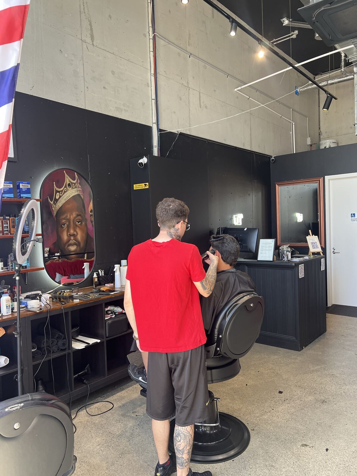 The barbershop corner with its lit oval mirror
